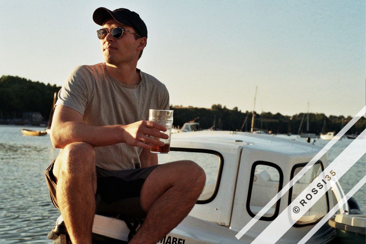 Relaxed portrait on a boat at golden hour, shot on 35mm film